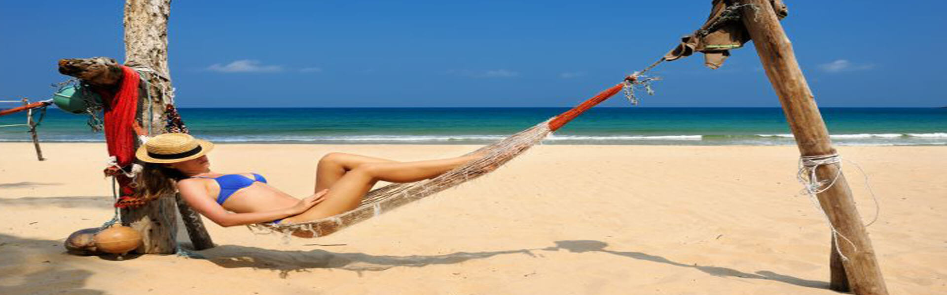 Picture of a woman at the Cabo beach laying on a hammock